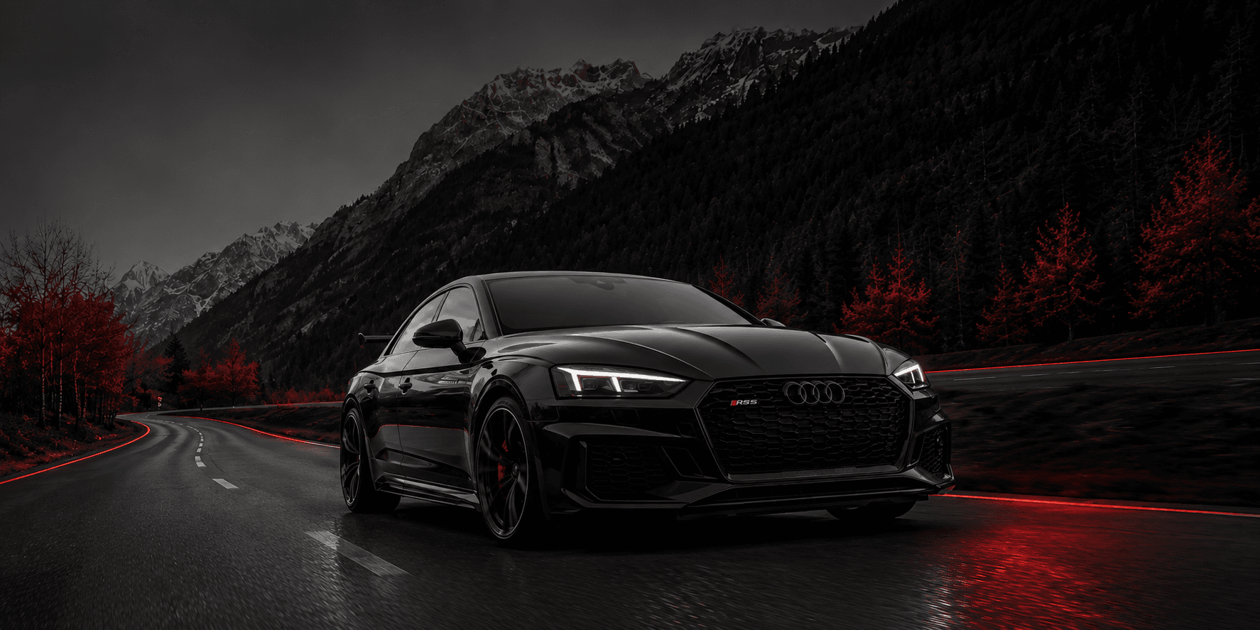 Black luxury car on a mountain road